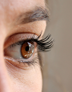 close up of brown eye making eye-contact